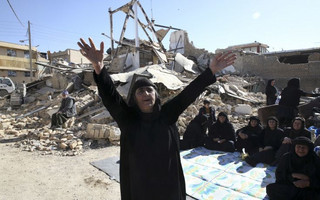 A woman mourns at an earthquake site in Sarpol-e-Zahab in western Iran, Tuesday, Nov. 14, 2017. Rescuers are digging through the debris of buildings felled by the Sunday earthquake in the border region of Iran and Iraq. (AP Photo/Vahid Salemi)