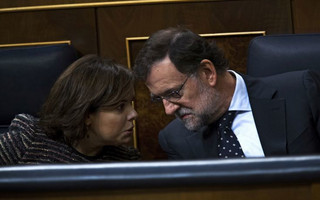 Spain's Prime Minister Mariano Rajoy, right, talks to Deputy Minister Soraya Saenz de Santamaria during the opening ceremony of the new parliamentary term at the Spanish parliament in Madrid, Spain, Thursday, Nov. 17, 2016. Spain's Prime Minister Mariano Rajoy will begin a second term in office, this time with a minority government after the parliamentary vote ended a 10-month political deadlock following two inconclusive elections. (AP Photo/Francisco Seco)