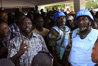FILE-In this file photo taken on Wednesday, Nov. 9, 2011, opposition leader George Weah, left, is protected by United Nations peacekeepers from Nigeria as he speaks to supporters at opposition party headquarters in Monrovia, Liberia. President Ellen Johnson Sirleaf's son, who is running for a Senate seat, has filed a lawsuit contesting her Ebola-related ban on political rallies. Ahead of the Dec. 16, 2014, election, the president banned gatherings in the capital, citing fears they could help spread Ebola. (AP Photo/Rebecca Blackwell, File) FILE-In this file photo taken on Wednesday, Nov. 9, 2011, opposition leader George Weah, left, is protected by United Nations peacekeepers from Nigeria as he speaks to supporters at opposition party headquarters in Monrovia, Liberia. President Ellen Johnson Sirleaf's son, who is running for a Senate seat, has filed a lawsuit contesting her Ebola-related ban on political rallies. Ahead of the Dec. 16, 2014, election, the president banned gatherings in the capital, citing fears they could help spread Ebola. (AP Photo/Rebecca Blackwell, File)