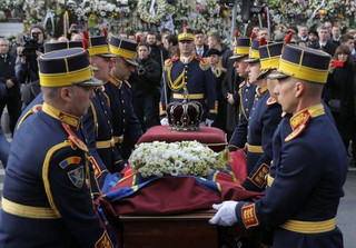 Honor guard soldiers carry the coffin of the late Romanian King Michael during the funeral ceremony outside the former royal palace in Bucharest, Romania, Saturday, Dec.16, 2017. Thousands waited in line to pay their respects to Former King Michael, who ruled Romania during WWII, and died on Dec. 5, 2017, aged 96, in Switzerland. (AP Photo/Vadim Ghirda)