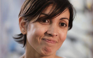 Adriana, daughter of two activists who were killed during the Argentine dictatorship in 1976, smiles after a news conference in Buenos Aires, Argentina, Tuesday, Dec. 5, 2017. The human rights group Grandmothers of the Plaza de Mayo said Tuesday that DNA tests have determined the real identity of Adriana, the missing daughter of Violeta Graciela Ortolani and Edgardo Roberto Garnier, bringing the number of cases of recovered stolen children from the Argentine dictatorship to 126. (AP Photo/Victor R. Caivano)