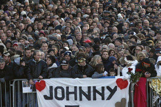 People wait outside the Madeleine church to attend French rock star Johnny Hallyday's funeral ceremony, in Paris, France, Saturday, Dec. 9, 2017. France is bidding farewell to its biggest rock star, honoring Johnny Hallyday with an exceptional funeral procession down the Champs-Elysees, a presidential speech and a motorcycle parade — all under intense security. (AP Photo/Thibault Camus)