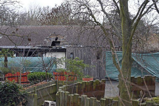 Damage is seen to the Adventure Cafe and Shop at London Zoo in London, Sunday, Dec. 24, 2017.  London Zoo has reopened, one day after a fire that killed four meerkats and an aardvark. The zoo said on its website Sunday it will operate normally, including visits with Santa. It says fire experts are confident the zoo can operate safely. (Victoria Jones/PA via AP)