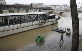 A man walks along the flooded banks of the Seine river after heavy rain in Paris, France, Tuesday, Jan. 9, 2018. (AP Photo/Michel Euler)