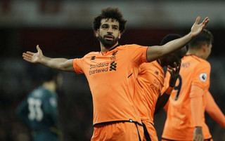 Liverpool's Mohamed Salah celebrates after he scores his sides 2nd goal of the gameduring their English Premier League soccer match between Arsenal and Liverpool at the Emirates stadium London, Friday, Dec. 22, 2017. (AP Photo/Alastair Grant)