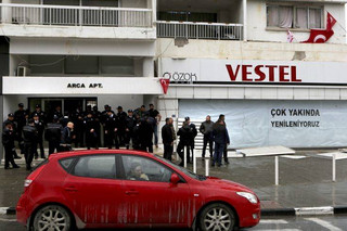 Police officers stand guard outside of the building of the Afrika newspaper office after it was attacked by supporters of the Turkish President Recep Tayyip Erdogan in the Turkish occupied northern part of the divided capital Nicosia, Cyprus, Monday, Jan. 22, 2018. Sener Levent told The Associated Press that Monday's attack was prompted by Turkish President Recep Tayyip Erdogan, who urged supporters to "answer" Afrika newspaper for suggesting that Turkey's military offensive into Syria against an enclave controlled by a U.S.-backed Syrian Kurdish militia was a bid to occupy that country's territory. (AP Photo/Petros Karadjias)