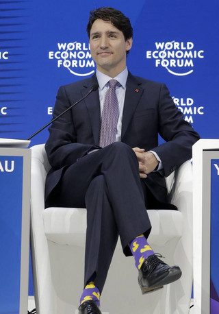 Justin Trudeau, Prime Minister of Canada, sports duck socks during the annual meeting of the World Economic Forum in Davos, Switzerland, Thursday, Jan. 25, 2018. (AP Photo/Markus Schreiber)