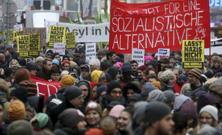 Protesters walk during a demonstration against the new Austrian government in Vienna Austria, Saturday, Jan. 13, 2018. (AP Photo/Ronald Zak)