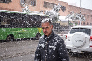 A man walks during a rare snowfall in Ouarzazate, south of the capital Rabat, Morocco, Monday, Jan. 29, 2018. The desert region saw snowfall for the first time in about 30 years. (AP Photo/Abdellah Azizi)