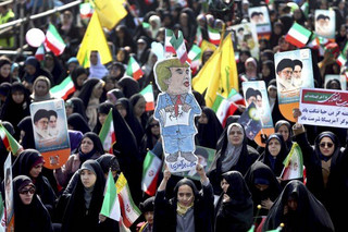 An Iranian girl holds up a caricature of U.S. President Donald Trump during a rally marking the 39th anniversary of the 1979 Islamic Revolution, in Tehran, Iran, Sunday, Feb. 11, 2018. Hundreds of thousands of Iranians rallied on the streets Sunday to mark the anniversary, just weeks after anti-government protests rocked cities across the country. (AP Photo/Ebrahim Noroozi)