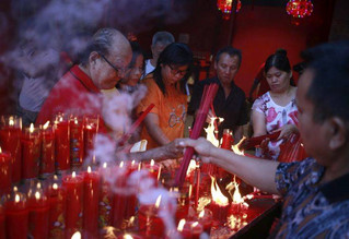 Indonesian ethnic Chinese light incense sticks during the celebration of Lunar New Year at a temple in the China Town in Jakarta, Indonesia, Friday, Feb. 16, 2018. The celebration marked the beginning of the Year of the Dog in Chinese calendar. (AP Photo/Dita Alangkara)