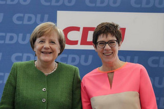 German Chancellor Angela Merkel, left, and the governor of German Saarland State and designated Christian Democratic Union party  Secretary General, Annegret Kramp-Karrenbauer, right, attend a party leaders' meeting in Berlin, Germany, Monday, Feb. 19, 2018. (AP Photo/Markus Schreiber)