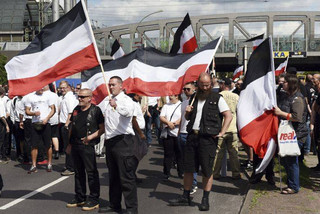 Far-right extremists gather to commemorate the death of Adolf Hitler's deputy, Rudolf Hess, in Berlin's western district  of Spandau, Saturday, Aug. 19, 2017.  Police are allowing the march, but participants are not allowed to glorify Hess, who died at Spandau prison 30 years ago. A counter demonstration is also expected.  (Maurizio Gambarini/dpa via AP)