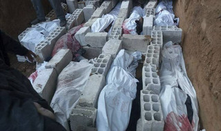 This photo released on Wednesday Feb. 21, 2018 provided by the Syrian anti-government activist group Ghouta Media Center, which has been authenticated based on its contents and other AP reporting, shows bodies of Syrians who were killed during airstrikes and shelling by Syrian government forces, buried on a mass grave, in Ghouta, suburb of Damascus, Syria. New airstrikes and shelling on the besieged, rebel-held suburbs of the Syrian capital killed at least 10 people on Wednesday, a rescue organization and a monitoring group said. (Ghouta Media Center via AP)