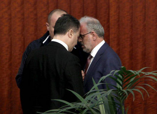 The lawmaker of the opposition VMRO DPMNE party Nikola Gruevski, left, confronts the parliament speaker Talk Xhaferi, right, during the voting for the law to make Albanian the second official language in the country, on a parliament session in Skopje, Macedonia, Wednesday, March 14, 2018. Macedonian parliament has approved for the second time the law making Albanian the second official language in the country after the country's president Gjorge Ivanov in January has vetoed the bill, describing it as unconstitutional and unnecessary.(AP Photo/Boris Grdanoski)