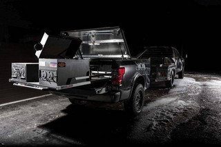 The heart of Smokin’ TITAN lies inside the custom trailer behind the truck. Since food smoking can create heat up to 600 degrees, the TITAN XD’s factory bed was removed from the truck and put on a B&S Custom trailer to prevent that heat from affecting the truck. The bed-trailer features two Nissan TITAN Boxes as lockable dry storage for the smoker pellets and wood chips flanking the smoker. Utilizing the TITAN’s innovative Utili-Track System, a B&S Customizing sliding tray was designed to easily slide the smoker in and out of the bed, supporting the custom Lang BBQ Smoker and Char Grill.
