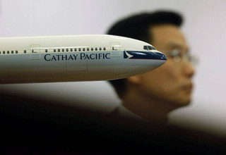 Chief Operating Officer of Cathay Pacific Airways Limited Ivan Chu responds to the Flight Attendants Union's industrial action during a news conference in Hong Kong Thursday, Dec. 13, 2012. Flight attendants at Hong Kong airline Cathay Pacific Airways are threatening to withhold food, alcohol and even smiles from passengers during the Christmas holidays over a pay dispute, a union official said Thursday. Cabin staff at the airline, which has a reputation for top-notch service, voted at a union meeting this week in favor of industrial action that could also result in flight delays. (AP Photo/Kin Cheung)