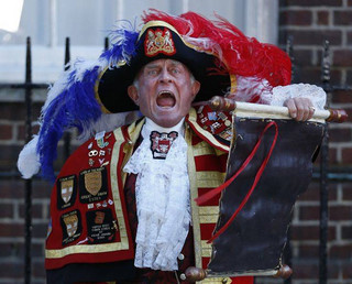 FOR USE AS DESIRED, YEAR END PHOTOS - FILE - Tony Appleton, a town crier,  announces the birth of the royal baby, outside St. Mary's Hospital exclusive Lindo Wing in London, Monday, July 22, 2013.  (AP Photo/Lefteris Pitarakis, File)