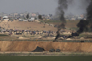 Israeli soldiers are seen as Palestinian demonstrators protest at the Israel Gaza border, Friday, April 6, 2018. Palestinians torched tires near Gaza's border with Israel on Friday, sending huge plumes of black smoke into the air and drawing tear gas and live fire from Israeli soldiers deployed on the other side of the border fence. (AP Photo/Tsafrir Abayov)