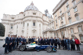 Pope Francis poses with the Formula E electric official car, at the Vatican, Wednesday, April 11, 2018. A Formula E race will be held in Rome EUR district, Saturday, April 14. (Vatican Media via AP)