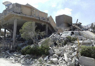 In this photo released by the Syrian official news agency SANA, shows the damage of the Syrian Scientific Research Center which was attacked by U.S., British and French military strikes to punish President Bashar Assad for suspected chemical attack against civilians, in Barzeh, near Damascus, Syria, Saturday, April 14, 2018. A Syrian military statement said in all, 110 missiles were fired by the U.S., Britain and France and that most of them were shot down or derailed. Russia's military said Syrian air defense units downed 71 out of 103 cruise missiles launched by the U.S. and its allies. (SANA via AP)
