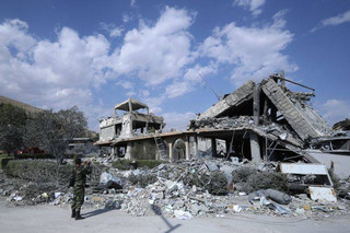 A Syrian soldier films the damage of the Syrian Scientific Research Center which was attacked by U.S., British and French military strikes to punish President Bashar Assad for suspected chemical attack against civilians, in Barzeh, near Damascus, Syria, Saturday, April 14, 2018. The Pentagon says none of the missiles filed by the U.S. and its allies was deflected by Syrian air defenses, rebutting claims by the Russian and Syrian governments. Lt. Gen. Kenneth McKenzie, the director of the Joint Staff at the Pentagon, also says there also is no indication that Russian air defense systems were employed early Saturday in Syria. (AP Photo/Hassan Ammar)