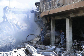 Firefighrers extinguish smoke that rises from the damage of the Syrian Scientific Research Center which was attacked by U.S., British and French military strikes to punish President Bashar Assad for suspected chemical attack against civilians, in Barzeh, near Damascus, Syria, Saturday, April 14, 2018. The Pentagon says none of the missiles filed by the U.S. and its allies was deflected by Syrian air defenses, rebutting claims by the Russian and Syrian governments. Lt. Gen. Kenneth McKenzie, the director of the Joint Staff at the Pentagon, also says there also is no indication that Russian air defense systems were employed early Saturday in Syria. (AP Photo/Hassan Ammar)