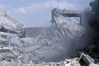 A fireman extinguishes smoke that rises from the damage of the Syrian Scientific Research Center which was attacked by U.S., British and French military strikes to punish President Bashar Assad for suspected chemical attack against civilians, in Barzeh, near Damascus, Syria, Saturday, April 14, 2018. The Pentagon says none of the missiles filed by the U.S. and its allies was deflected by Syrian air defenses, rebutting claims by the Russian and Syrian governments. Lt. Gen. Kenneth McKenzie, the director of the Joint Staff at the Pentagon, also says there also is no indication that Russian air defense systems were employed early Saturday in Syria. (AP Photo/Hassan Ammar)