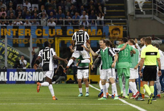 Juventus' Douglas Costa, center top, celebrates with teammates after scoring his side's opening goal during the Serie A soccer match between Inter Milan and Juventus at the San Siro stadium in Milan, Italy, Saturday, April 28, 2018. (AP Photo/Antonio Calanni)