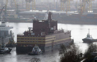 The floating nuclear power plant, the 'Akademik Lomonosov', is towed out of the St. Petersburg shipyard where it was constructed in St.Petersburg, Russia, Saturday, April 28, 2018. The Akademik Lomonosov is to be loaded with nuclear fuel in Murmansk, then towed to position in the Far East in 2019.(AP Photo/Dmitri Lovetsky)