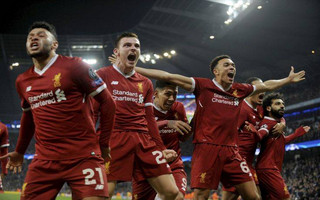 Liverpool's Mohamed Salah, right on the end, celebrates scoring his side's first goal with his teammates in front of their fans during the Champions League quarterfinal second leg soccer match between Manchester City and Liverpool at Etihad stadium in Manchester, England, Tuesday, April 10, 2018. (AP Photo/Rui Vieira)