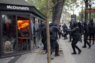 A McDonald's restaurant is hit with petrol bombs thrown by activists during the traditional May Day rally in the center of Paris, France, Tuesday, May 1, 2018. Each year, people around the world take to the streets to mark International Workers' Day, or May Day. (AP Photo/Francois Mori)