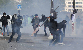 Activists clash with riot police during the traditional May Day rally in the center of Paris, France, Tuesday, May 1, 2018. Each year, people around the world take to the streets to mark International Workers' Day, or May Day. (AP Photo/Francois Mori)