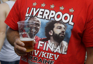 Liverpool supporter gathers in Kiev, Ukraine, Friday, May 25, 2018. Supporters were gathering in Kiev ahead of the Champions League final soccer match between Real Madrid and Liverpool on Saturday May 26. (AP Photo/Efrem Lukatsky)
