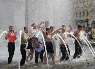 School graduates splash in a fountain as they enjoy the warm weather while celebrating their last day at school in Kiev, Ukraine, Friday, May 25, 2018. Young Ukrainians today celebrate 'Last Ring,' a celebration of their last day of school. (AP Photo/Sergei Grits)