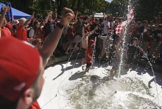 Liverpool supporters react as they stand in a fountain in Kiev, Ukraine, Saturday, May 26, 2018. Supporters were gathering in Kiev ahead of the Champions League final soccer match between Real Madrid and Liverpool later Saturday. (AP Photo/Andrew Kravchenko)