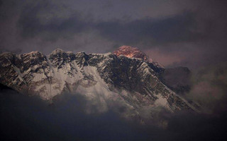 FILE - In this Oct. 27, 2011 file photo, the last light of the day sets on Mount Everest as it rises behind Mount Nuptse as seen from Tengboche, in the Himalaya's Khumbu region, Nepal. Famed Swiss climber Ueli Steck was killed Sunday, April 30, 2017, in a mountaineering accident near Mount Everest in Nepal, expedition organizers said. Mingma Sherpa of the Seven Summit Treks said Steck was killed at Camp 1 of Mount Nuptse. (AP Photo/Kevin Frayer, File)