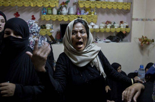 Relatives of Palestinian volunteer paramedic Razan Najjar, 21, mourn at the family house during her funeral in town of Khan Younis, southern Gaza Strip, Saturday, June 2, 2018. Najjar was killed by Israeli fire Friday during mass protests in the Gaza Strip, the Palestinian Health Ministry said. (AP Photo/Khalil Hamra)