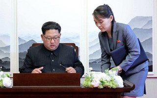 FILE - In this Friday, April 27, 2018, file photo, North Korean leader Kim Jong Un signs a guestbook next to his sister Kim Yo Jong, right, inside the Peace House at the border village of Panmunjom in Demilitarized Zone. Kim’s younger sister handed her brother a pen when he signed the guestbook. Her proximity to her brother during most of the summit events Friday added credence to speculation that she’s virtually the No.2 in the North. (Korea Summit Press Pool via AP, File)