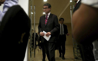 Japan's Foreign Minister Taro Kono arrives at a news conference after a meeting on the "Corridor for Peace and Prosperity," at Dead Sea, Jordan, Sunday, April 29, 2018. (AP Photo/Raad Adayleh)