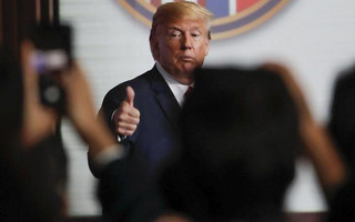 U.S. President Donald Trump flashes a thumbs up as he leaves after a press conference at the Capella resort on Sentosa Island Tuesday, June 12, 2018 in Singapore. (AP Photo/Wong Maye-E)