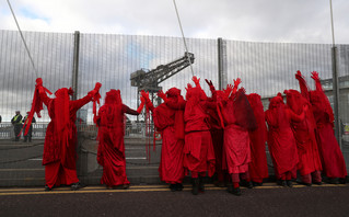 Activists in red uniforms in Glasgow