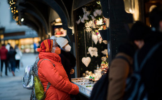 Citizens with masks at a Christmas market in Vienna Citizens with masks at a Christmas market in Vienna