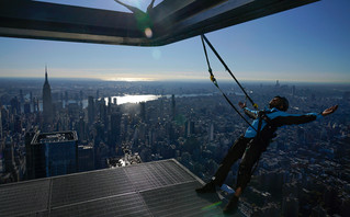 A man with ropes on a skyscraper