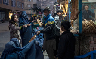 Man distributes bread in Afghanistan