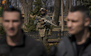 A Ukrainian serviceman guards the area as Kyiv Mayor Vitali Klitschko, right, speaks during a press conference next to his brother, former heavyweight boxing world champion Wladimir Klitschko, in Kyiv, Ukraine,Wednesday, March 23, 2022. From a public park in the city, Klitschko said 264 civilians had so far died from Russian bombardment on the capital, including four children. As he spoke to reporters, explosions and loud gunfire echoed across the city A Ukrainian serviceman guards the area as Kyiv Mayor Vitali Klitschko, right, speaks during a press conference next to his brother, former heavyweight boxing world champion Wladimir Klitschko, in Kyiv, Ukraine,Wednesday, March 23, 2022. From a public park in the city, Klitschko said 264 civilians had so far died from Russian bombardment on the capital, including four children. As he spoke to reporters, explosions and loud gunfire echoed across the city