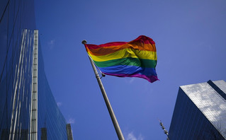 A rainbow flag flutters in the wind at the financial quarter in Brussels, Thursday, March 11, 2021