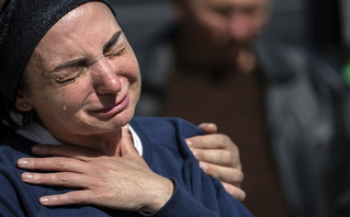 Relatives mourn the death of territorial defense soldiers who were killed by Russian army during their funeral in Irpin