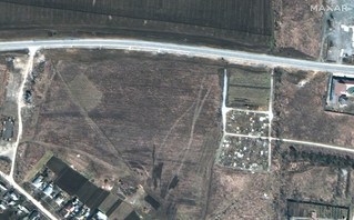 This satellite image provided by Maxar Technologies on Thursday, April 21, 2022 shows an overview of the cemetery in Manhush, some 20 kilometers west of Mariupol, Ukraine, on March 19, 2022