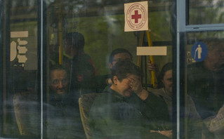 From left, Serhii Tsybulchenko, Ihor Trotsak, Tetyana Trotsak and Elina Tsybulchenko, who fled from the Azovstal steel plant in Mariupol, Ukraine, arrive by bus to a reception center for displaced people in Zaporizhzhia, Ukraine, Tuesday, May 3, 2022